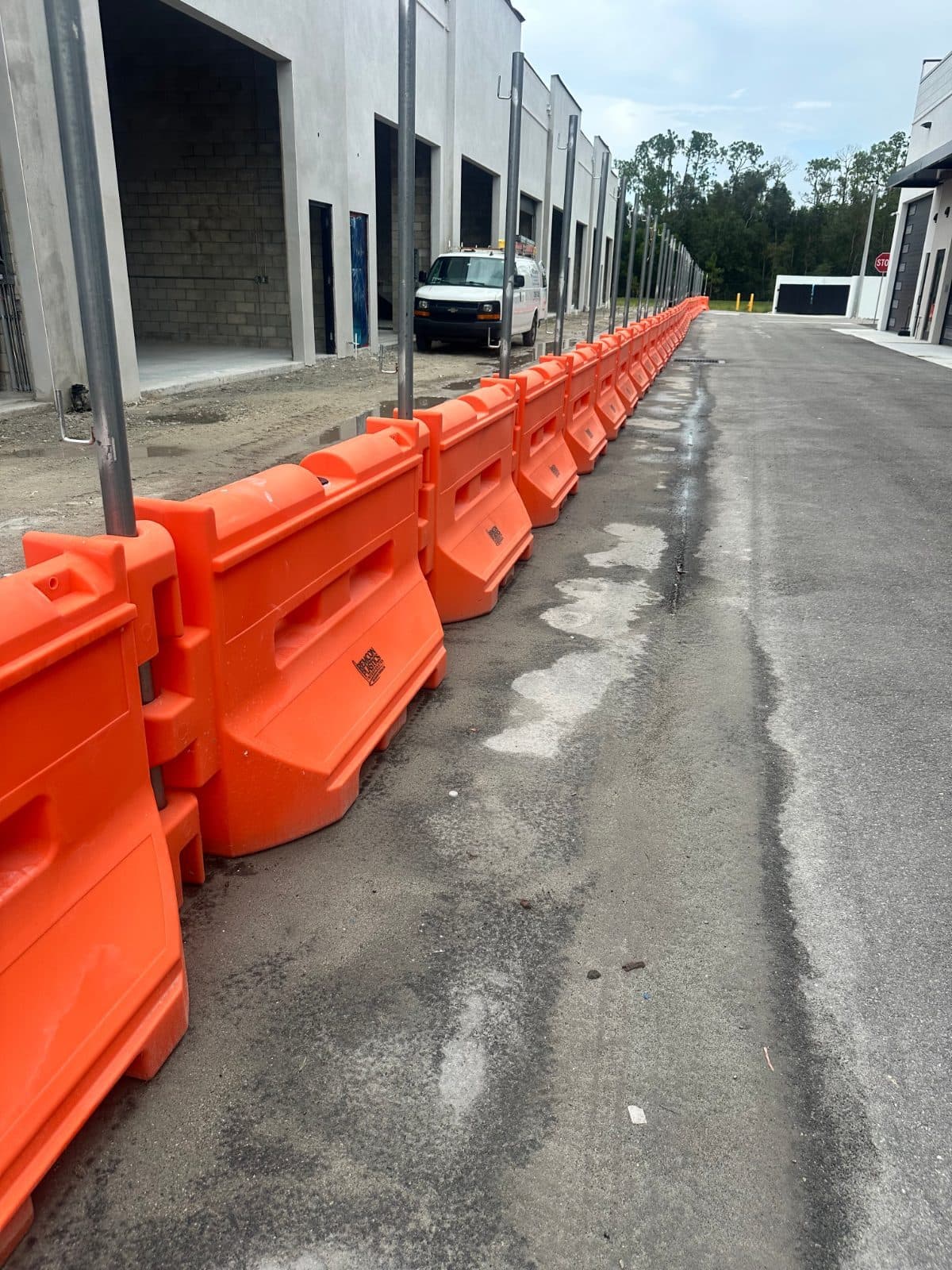 75 Remcon water filled orange barricades with privacy fence 2
