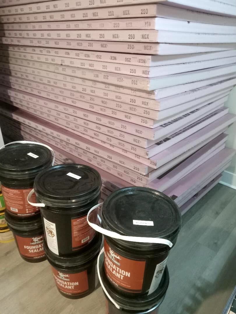 Unused Rigid Foam Board Insulation and Liquid Rubber Foundation Sealant